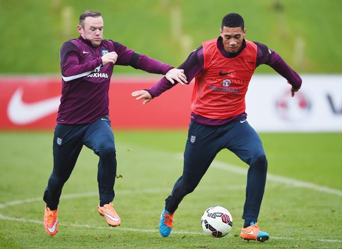 Chris Smalling and Wayne Rooney in action during a training session