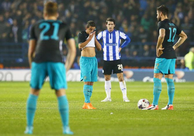 Dejected Arsenal players look on after conceding the opening goal against Sheffield Wednesday