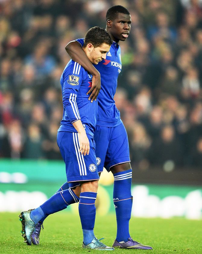 Chelsea's Eden Hazard is consoled by teammate Kurt Zouma after missing the final penalty during their Capital One League Cup tie against Stoke City at Britannia Stadium in Stoke on Trent on Tuesday