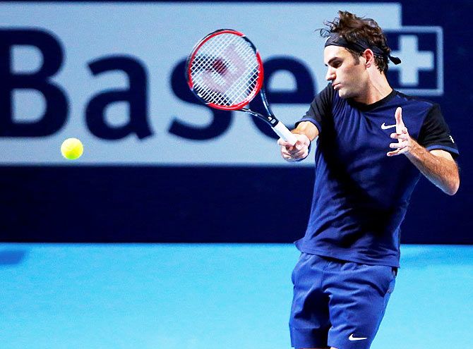 Switzerland's Roger Federer returns the ball to Kazakhstan's Mikhail Kukushkin during their match at the Swiss Indoors ATP men's tennis tournament in Basel, on Tuesday