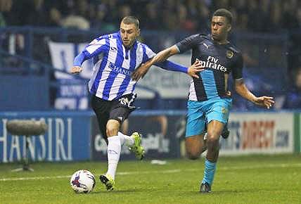 Sheffield Wednesday's Jack Hunt is challenged by Arsenal's Alex Iwobi