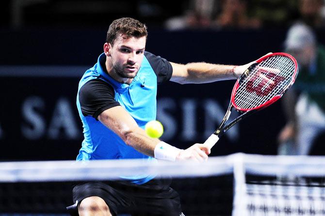 Grigor Dimitrov plays a return against Rafael Nadal