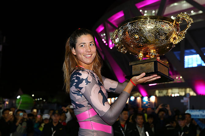 Garbine Muguruza of Spain holds the winners trophy 
