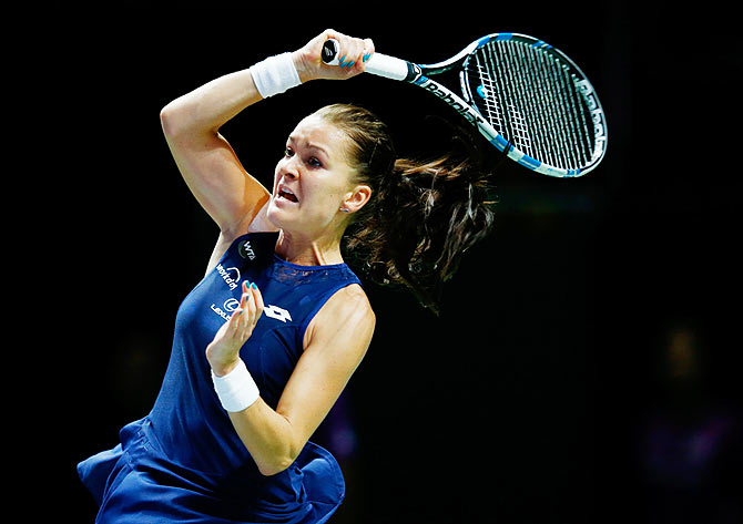 Poland's Agnieszka Radwanska in action against Romania's Simona Halep in a round robin match of the BNP Paribas WTA Finals at Singapore Sports Hub on Thursday