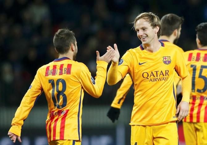 Barcelona's Ivan Rakitic (right) celebrates with teammate Jordi Alba after scoring against BATE Borisov during their Champions League Group E match at the Borisov Arena stadium outside Minsk, in Belarus, on Tuesday