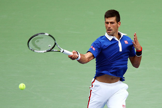 Serbia's Novak Djokovic returns a shot against Brazil's Joao Souza in their first round match on Monday