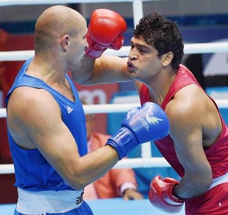 India's Satish Kumar, in red, in action against Kazakh Ivan Dychko during the Incheon Asian Games in 2014