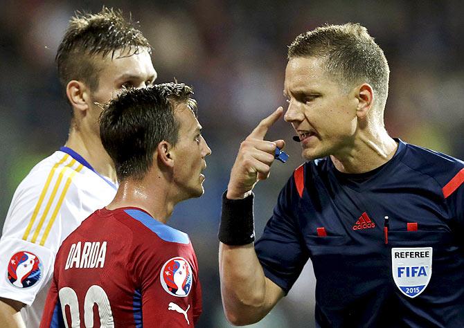 Referee Martin Strombergsson (right) speaks with Czech Republic's Vladimir Darida (centre) and Kazakhstan's Baurzhan Dzholchiyev during their match in Plzen, Czech Republic