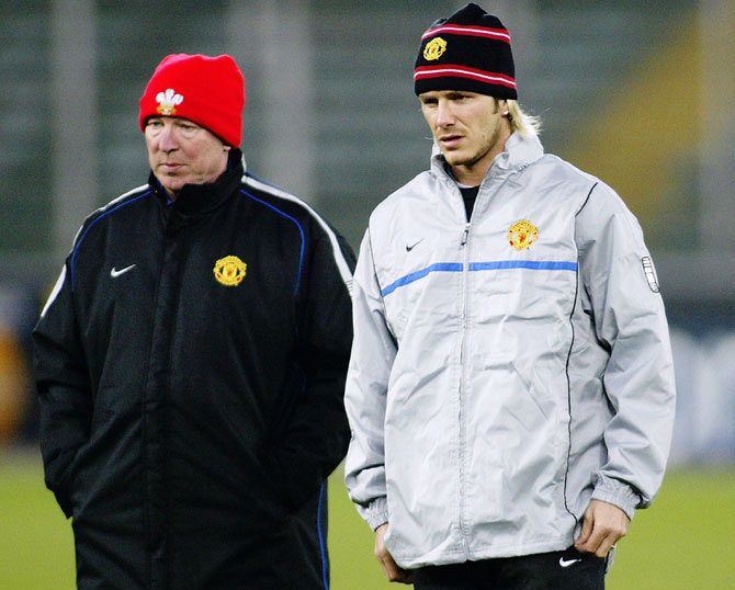 IMAGE: Manchester United Manager Sir Alex Ferguson talks with David Beckham during a training session