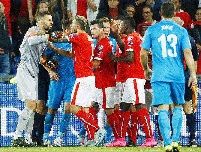 Switzerland's Valon Behrami argues with Slovenia's goalkeeper Samir Handanovic (left)