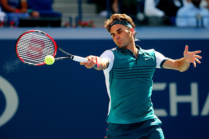 Switzerland's Roger Federer returns a shot to Germany's Philipp Kohlschreiber during their men's singles third round match of the 2015 US Open at the USTA Billie Jean King National Tennis Center in Flushing meadows in New York City on Saturday