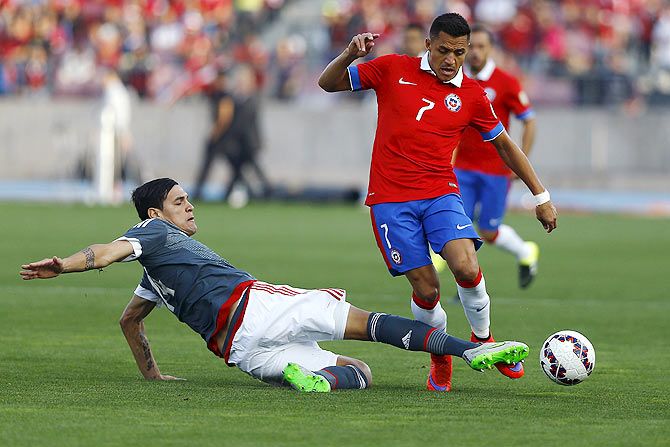 Paraguay's Gustavo Gomez (left) challenges Chile's Alexis Sanchez during their friendly match in Santiago, on Saturday