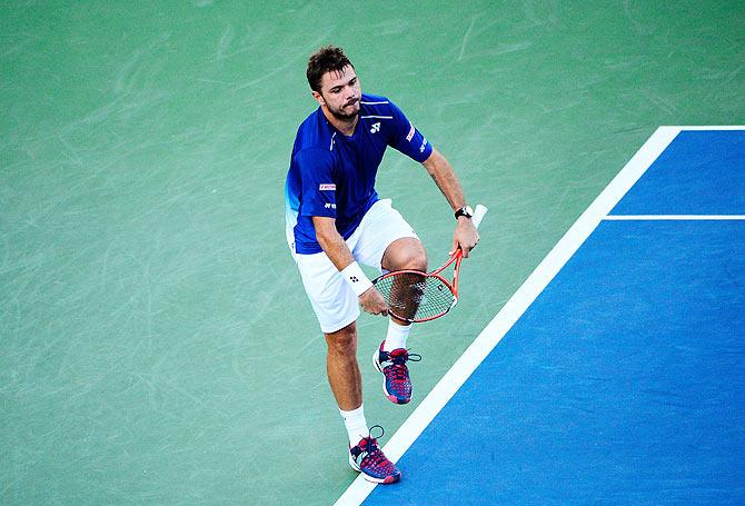 Switzerland' Stan Wawrinka breaks his racket during his match against Belgium's Ruben Bemelmans