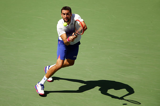 Croatia's Marin Cilic returns a shot to France's Jeremy Chardy