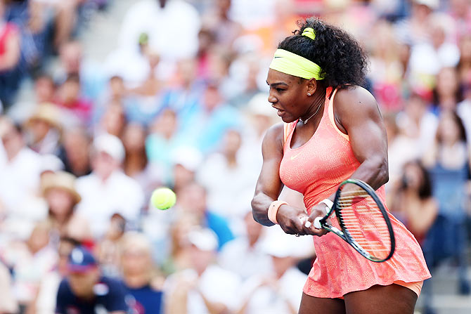 USA's Serena Williams returns a shot to compatriot Madison Keys