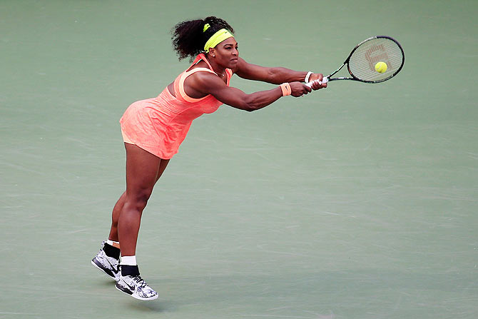 USA's Serena Williams returns a shot to compatriot Madison Keys