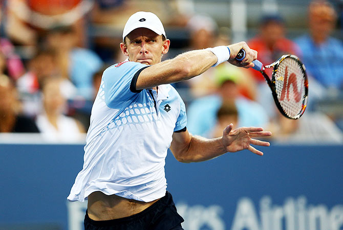 South Africa's Kevin Anderson returns a shot to Great Britain's Andy Murray