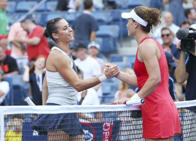 Italy's Flavia Pennetta is congratulated by Australia's Samantha Stosur