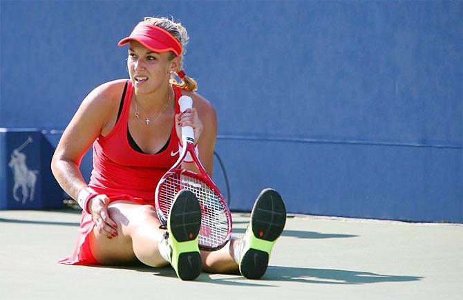 Germany'S Sabine Lisicki stretches between points in the third set of her match against Romania's Simona Halep