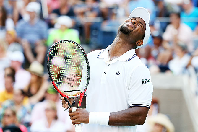 USA's Donald Young reacts after missing a point against Switzerland's Stanislas Wawrinka