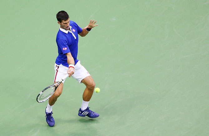 Serbia's Novak Djokovic returns a shot to Croatia's Marin Cilic during their 2015 US Open semi-final at USTA Billie Jean King National Tennis Center on Friday