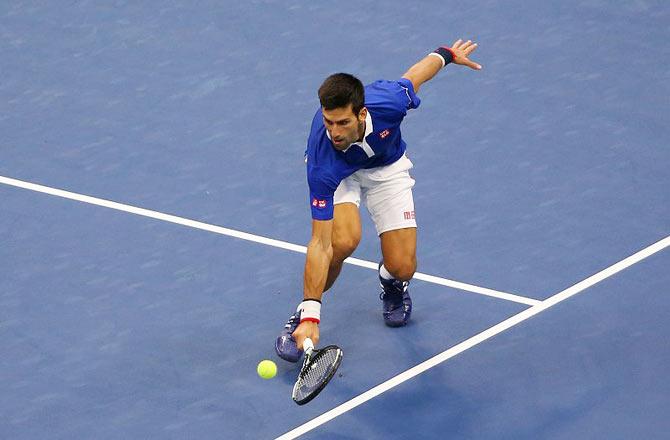 Novak Djokovic returns a shot to Marin Cilic