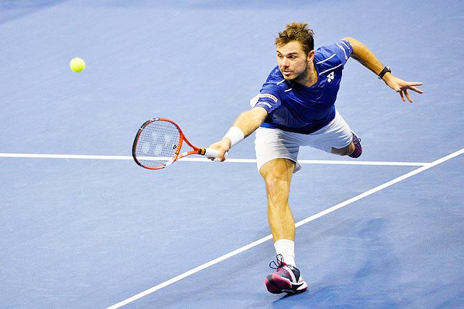 Switzerland's Stan Wawrinka returns a shot to compatriot Roger Federer