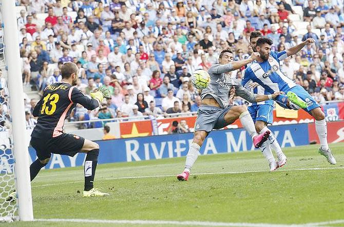 Real Madrid's Cristiano Ronaldo (centre) gets into a scramble with Espanyol's Ruben Duarte (right) and Pau Lopez (left) before scoring