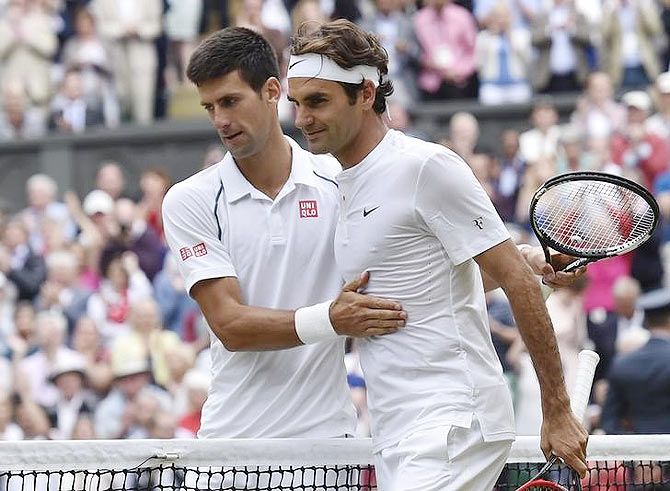 Serbia's Novak Djokovic embraces Switzerland's Roger Federer at the net