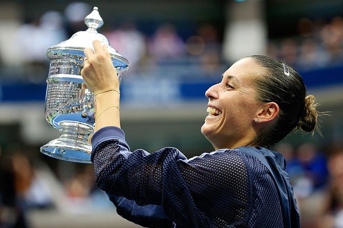 Italy's Flavia Pennetta celebrates with the winner's trophy after defeating compatriot Roberta Vinci in their US Open final match at the USTA Billie Jean King National Tennis Center at Flushing Meadows in New York City on Sarturday