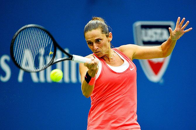 Roberta Vinci plays a forehand return to Flavia Pennetta