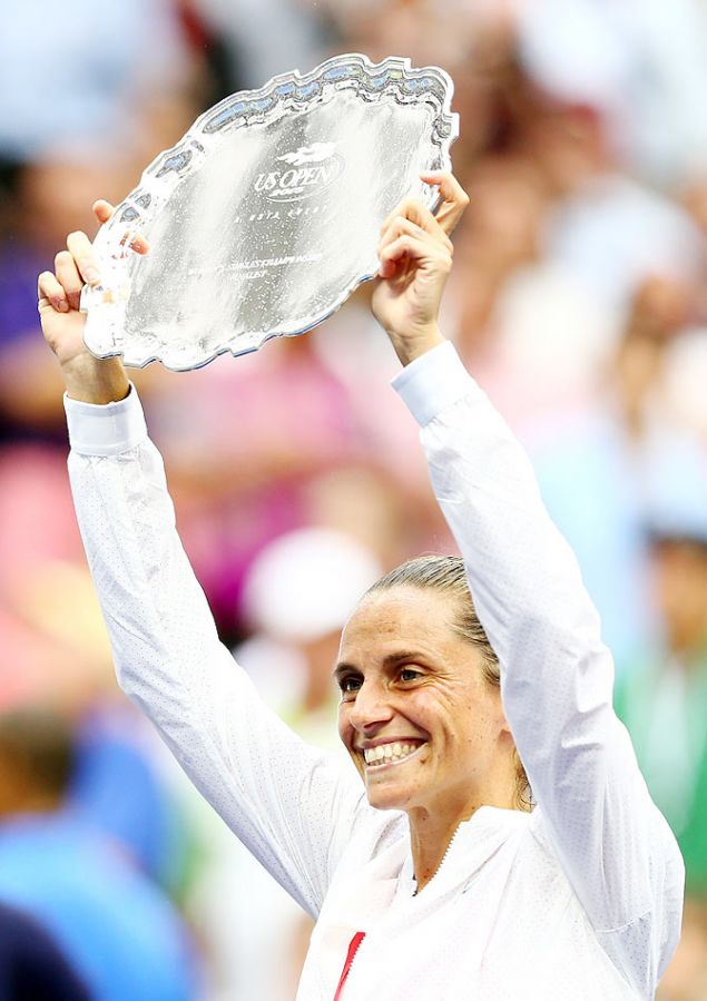 Italy's Roberta Vinci hoists the runners-up trophy after losing to compatriot Flavia Pennetta in the US Open singles final on Saturday