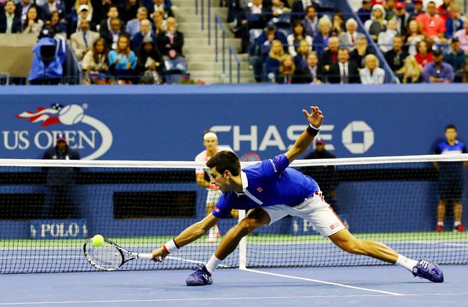 Novak Djokovic misses a backhand shot against Roger Federer