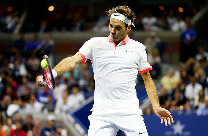 Roger Federer returns a backhand shot to Novak Djokovic