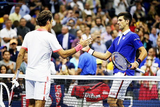 Novak Djokovic greets Roger Federer at the net after winning the US Open on Sunday