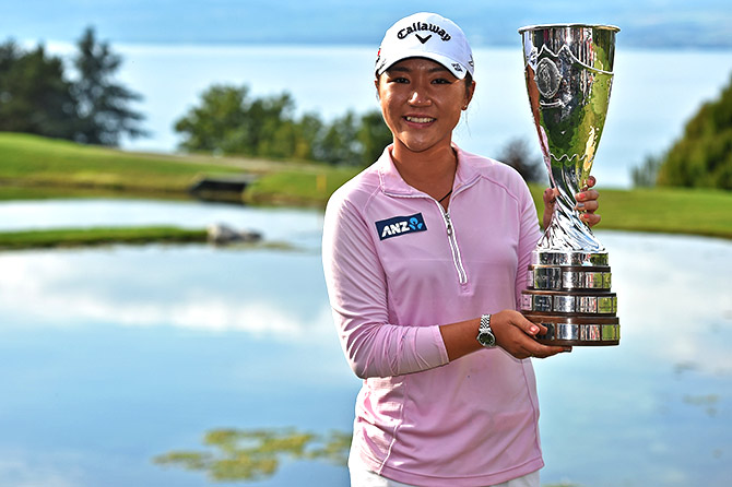Lydia Ko of New Zealand holds the trophy after winning the Evian Championship 