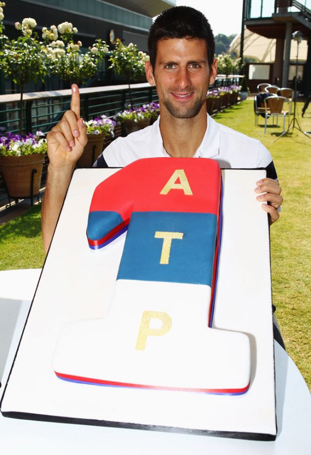 Novak Djokovic poses with a cake decorated in the colours of the Serbian flag as he celebrates becoming the new World Number 1 tennis player on July 4, 2011 after defeating Andy Murray in the Wimbledon semi-final