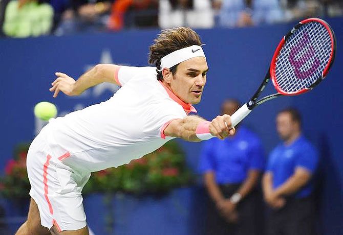 Roger Federer stretches to play return against Novak Djokovic