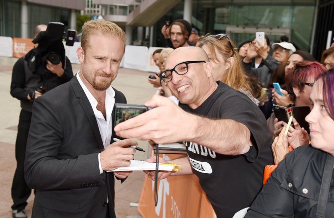 Actor Ben Foster takes a selfie with fans at 'The Program' premiere during the 2015 Toronto International Film Festival at Roy Thomson Hall in Toronto on Sunday