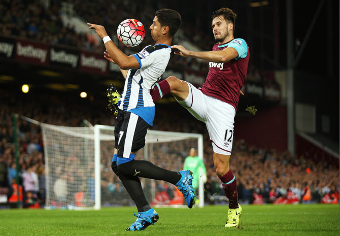 Newcastle United's Ayoze Perez (left) is challenged by West Ham United's Carl Jenkinson