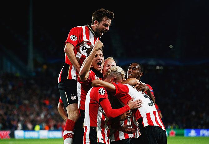 PSV Eindhoven players celebrate Hector Moreno's goal against Manchester United during the UEFA Champions League Group B match at PSV Stadion in Eindhoven on Tuesday