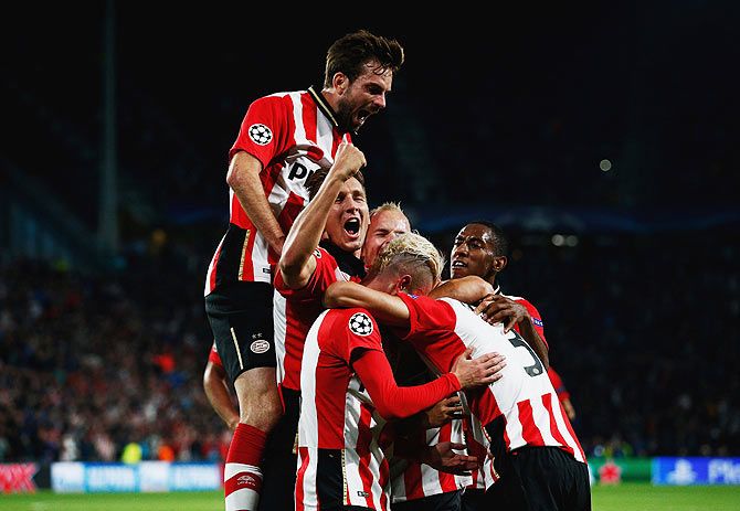 PSV Eindhoven players celebrate Hector Moreno's goal against Manchester United during the UEFA Champions League Group B match at PSV Stadion in Eindhoven on Tuesday