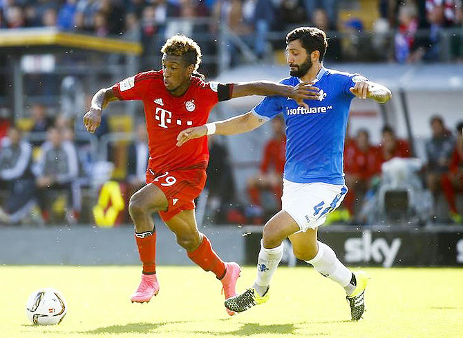 Bayern Munich's Kingsley Coman challenges Darmstadt 98 Aytac Sulu (right) during their Bundesliga match in Darmstadt, Germany on Saturday