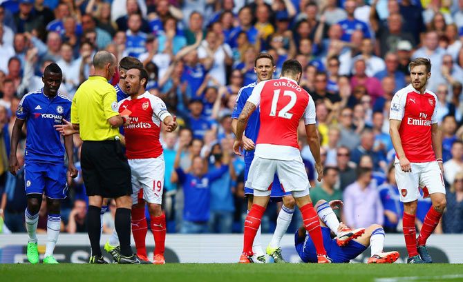 Arsenal's Santi Cazorla is shown a red card by referee Mike Dean