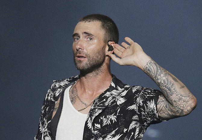 Adam Levine gestures to the crowd