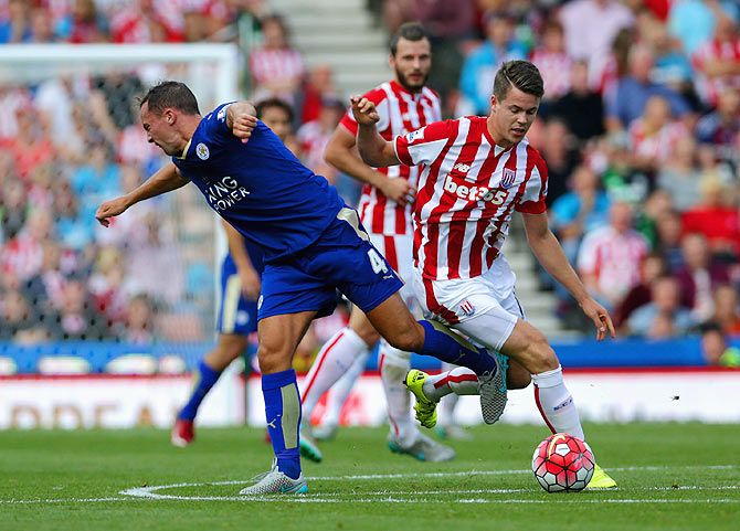 Stoke City's Marco van Ginkel and Leicester City's Danny Drinkwater compete for the ball during their English Premier League match at Britannia Stadium in Stoke on Trent, on Saturday