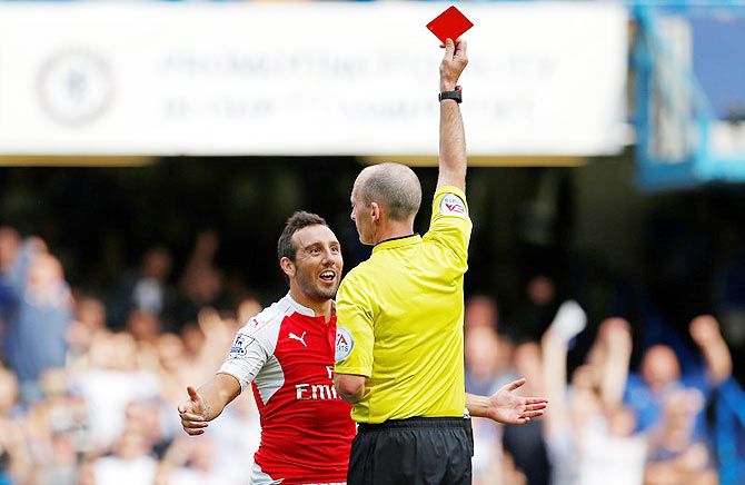 Arsenal's Santi Cazorla is shown a red card by referee Mike Dean 