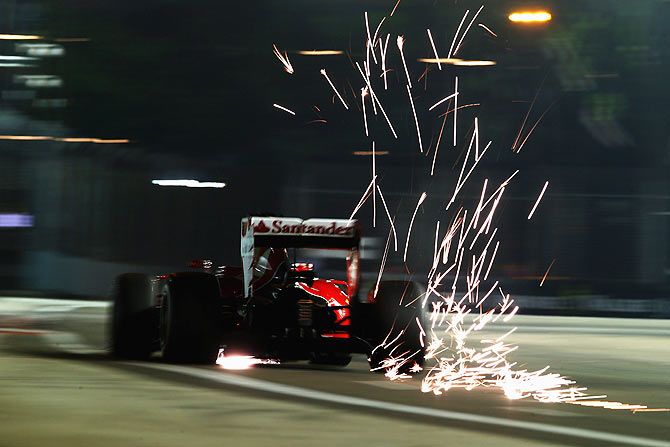 Sparks fly off Sebastian Vettel's car during qualifying at the Singapoe GP on Saturday