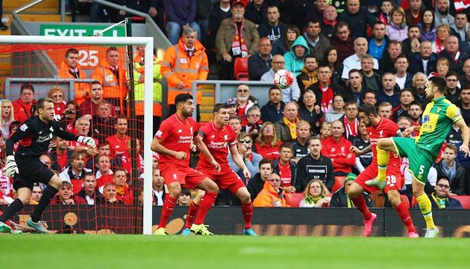 Norwich City's Russell Martin, right, scores