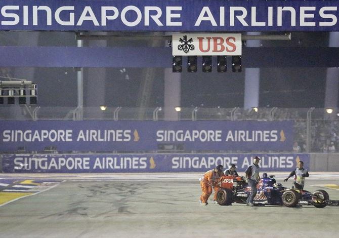 Race officials push the car